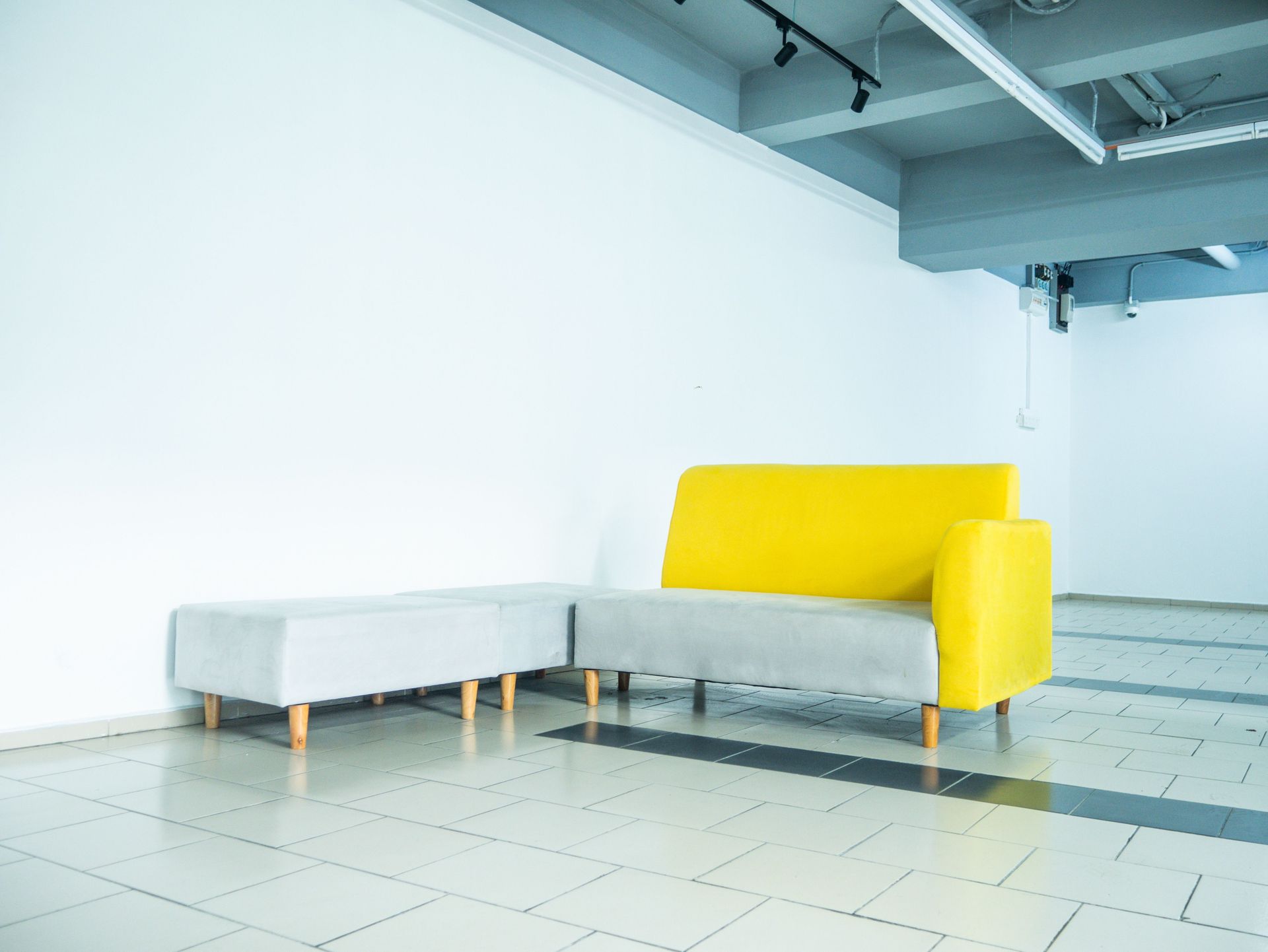 Bright yellow and gray minimalist couch in a contemporary Kuala Lumpur interior.
